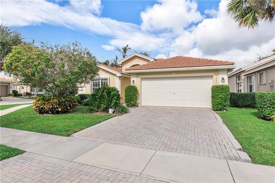 Spectacular 3/2 single family home on a corner lot in 55+ Valencia Falls.  View the lake from your extended, screened-in patio.  Open floor plan with crown molding details.  Primary suite has a tray ceiling with 2 walk-in closets.  The primary bath has separate sinks/ vanities, Roman tub and a walk-in shower.   The eat-in kitchen features wood cabinets, upgraded counter with decorative backsplash and a large pantry.  The 3rd bedroom may be utilized as an office or den.  All windows and sliders contain hurricane accordion shutters. The unit contains an alarm system.  Separate laundry room.  Internet, Cable, and lawn service included.  Community is guard gated.  Active clubhouse with a cafe, resort pool/ spa, social hall, fitness center, pickle ball, and numerous activities.