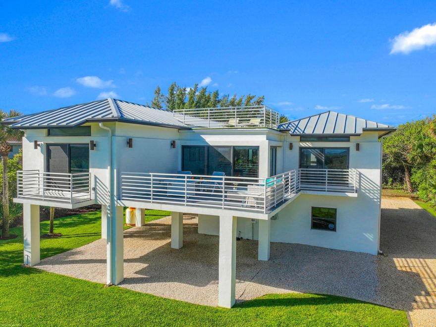 Completely renovated in 2023 this beautiful modern home has commanding ocean views just yards from the surf. The poured cement home has impact glass windows, doors and is set high on concrete pilings. Solar array panels on it's galvalume metal roof keep utility bills to a minimum. Located on a quiet stretch of Jupiter Island yet minutes to restaurants, shopping and Palm Beach International Airport it's the perfect blend of privacy and convenience. Open floor plan with ocean views from living, dining and primary bedroom suite There is room for a pool. Landscape plans with pool placement are located under documents tab on MLS.
