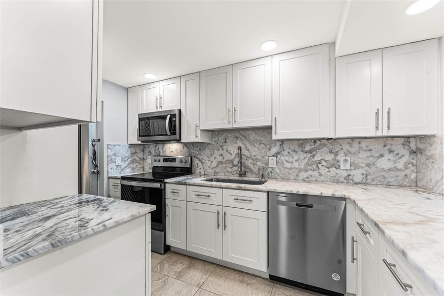 This 2-bed 2-bath first-floor residence is fully remodeled and features matching tile flooring throughout, SS appliances, impact windows, and a well spaced bedroom layout with walk-in closets. The screened patio sits just steps from the pool, with parking and the laundry room both conveniently nearby. Residents enjoy access to a heated pool, fitness center, and shuffleboard, along with a community dock offering ocean access for kayaks, paddleboards, and boat dockage when available. The community is adjacent to Dan Witt Park, walking distance to Packy’s Sports Bar and Papa’s Raw Bar, minutes from Deerfield’s Blue Wave Award winning Beach, and perfectly positioned to enjoy the best of LHP living.