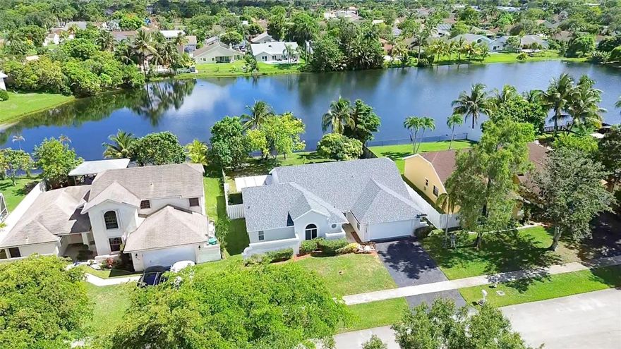 Welcome to your new lakefront oasis in the heart of South Florida! Wake up to serene lake views and enjoy your morning coffee in the spacious backyard surrounded by nature, fruit trees, and exotic wildlife. This 4-bed, 3-full bath house offers an open floor plan with high vaulted ceilings and recently renovated bathrooms, showers, and kitchen cabinets. This home has major upgrades done recently - including 2024 impact windows and doors, 2024 roof, and a 2025 central AC system. Conveniently located between Sawgrass Expressway and the Florida Turnpike, you’re just minutes from major roads, beaches, airports, and cities. Schedule a showing today and experience South Florida living at its finest!