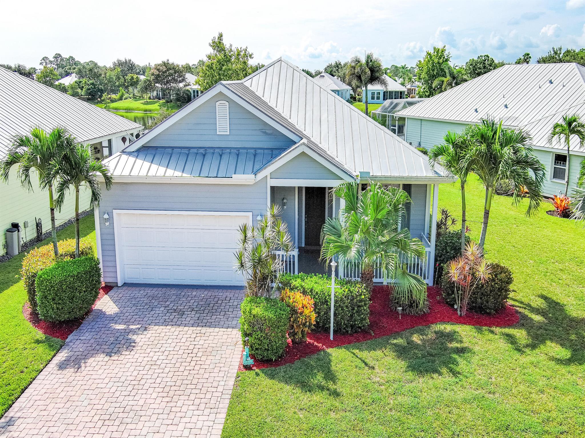 Welcome to this charming Key West-style lakefront home, where timeless design meets modern updates. Situated in the highly desirable River Place community of Port St. Lucie, this residence offers both comfort and convenience in a serene setting. Inside, the spacious open-concept kitchen flows seamlessly into the family room, ensuring you stay connected while entertaining or spending time with family. Also included in this 1499 sq ft home you will find an open concept separate living room and dining room as you enter the home from the front entryway. The back wrap-around screened porch with plank wood ceilings provides a peaceful spot to enjoy lake views and fresh breezes year-round. The flexible third bedroom, enhanced by glass French doors, can serve as a guest room, home office, or