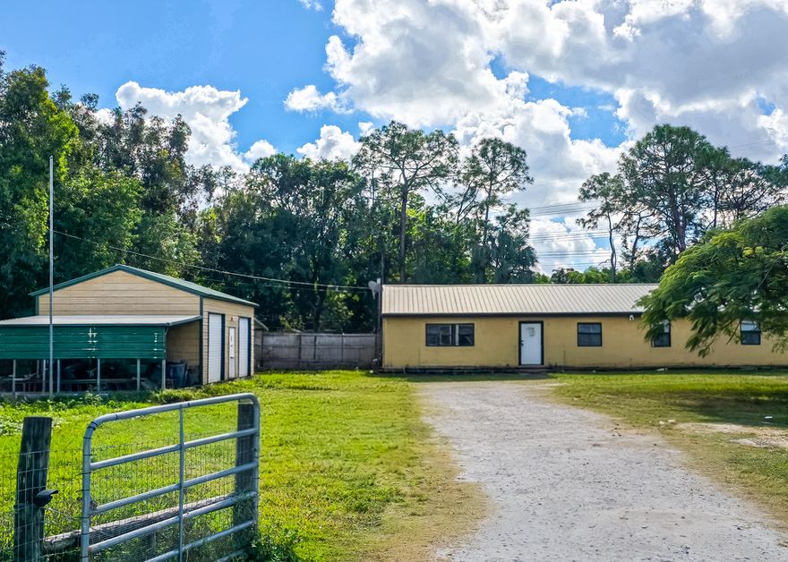 Opportunity awaits! Single-story ranch style home situated on a spacious 1.19-acre lot in The Acreage across from a scenic freshwater waterway, no neighbors to the right side, and nearby horse trails, offering a functional layout ideal for those seeking plenty of outdoor space, privacy, and flexibility.   Enjoy a quiet, peaceful country lifestyle while not being too far away from city life, restaurants, hospitals, airports, and shopping. All within 5-30 minutes away.   Property features a metal roof, a 2-car detached garage/workshop, two seperate entrances, laundry room, pond, and open yard suitable for equipment, storage, hobbies, or agricultural use.   Perfect for buyers prioritizing land, utility, and lifestyle potential over cosmetic updates. No HOA. Zoned for acreage living.