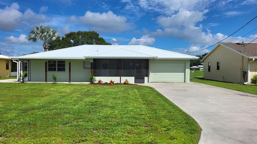 Turnkey move-in ready 3/2 CBS home with tip-top furnishings. Features: Waterfront, attached garage, metal roof, concrete boathouse with boat lift, irrigation system, partially fenced back yard, wood soft-close cabinets, AC 2023, fireplace, flawless flooring, 2 hall linen closets. Closet to the Locks to Lake Okeechobee in the quiet, desirable ''homes only'' section of Buckhead Ridge. An easy commute to either coast. No HOA, No flood zone. Make the move and move on up!