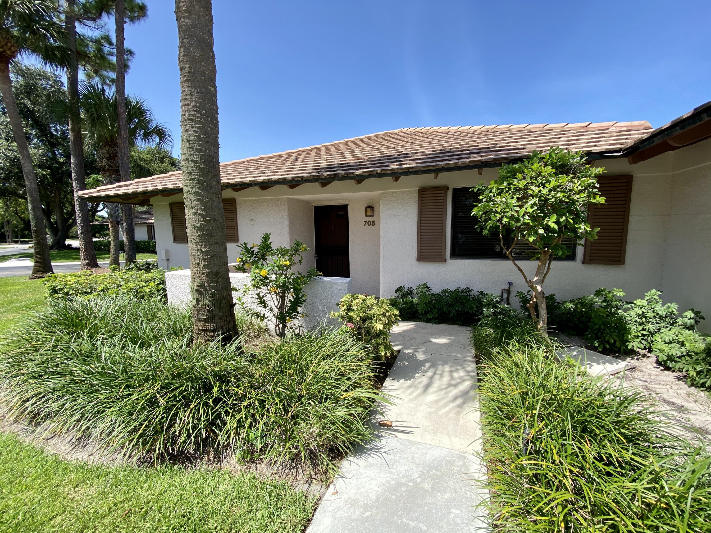Desirable, bright 2-bedroom, 2-bath updated end unit with ceramic tile flooring throughout. Kitchen features granite countertops, pantry for extra storage, spacious fridge, stacked W/D and bathrooms with granite vanities. Located by the Squire Golf Course in PGA National and walking distance to the world-renowned PGA Golf Club, Spa and Resort. Main living space is open with sliders to outdoor patio. Club Cottages offers a beautiful community pool and outdoor picnic area for residents. Access to all PGA resort amenities are available. This wonderful, quiet location offers affordable, resort-like living! $500 application fee covers cleaning fee and annual community rental expense. Minimum credit score of 650. RentSpree background check application link ($30):