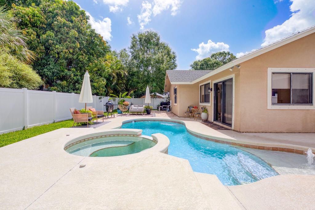 Photo of 801 NE Zebrina Senda, Jensen Beach, FL 34957 (MLS # R11097735)