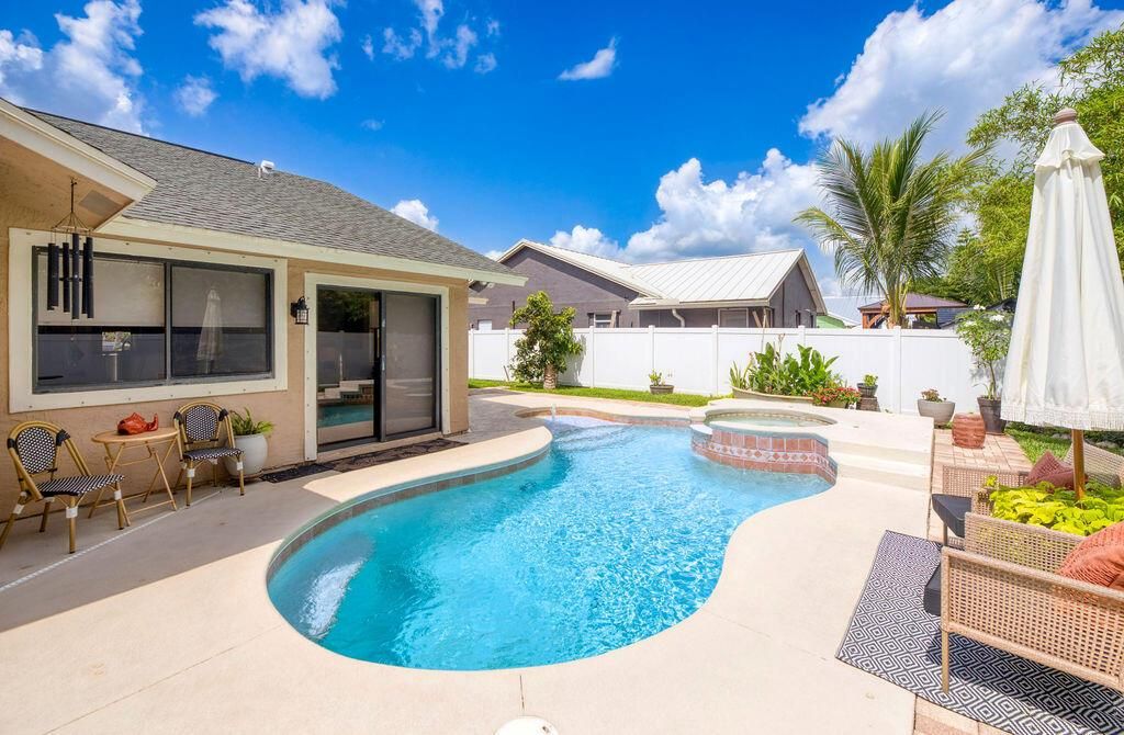 Photo of 801 NE Zebrina Senda, Jensen Beach, FL 34957 (MLS # R11097735)