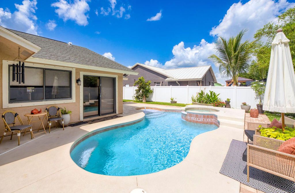 Photo of 801 NE Zebrina Senda, Jensen Beach, FL 34957 (MLS # R11097735)