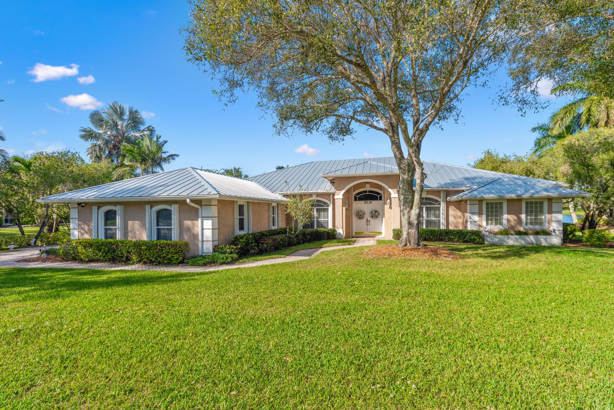 Captivating lakefront oasis with stunning views! Fantastic 4 bedroom PLUS office, 3 full bath, pool home nestled on a beautiful half acre lot with panoramic lakefront views. The living spaces are bathed in natural light, creating an inviting ambiance that complements the tranquil surroundings. The triple split floor plan offers privacy, making it an ideal haven for families or those who love to entertain. Spacious master bedroom is a true retreat. Ample closet space throughout caters to your storage needs. The office space provides the flexibility to work from home. Step outside to a large patio area overlooking the shimmering pool and the picturesque lake beyond. With it's small neighborhood feel and highly regarded Martin County school district.