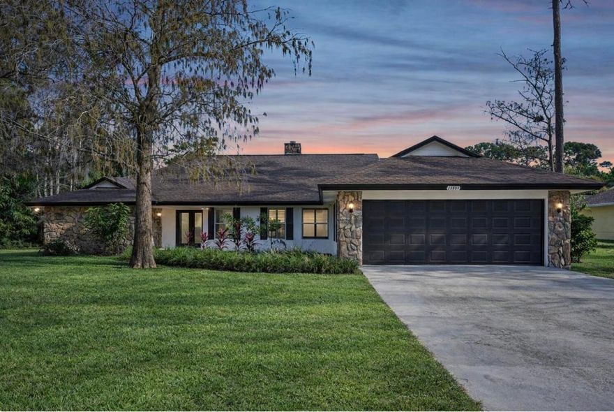 Welcome to 13253 La Mirada Circle, a 4-bed, 2.5-bath single-level home with 3,060 sq. ft. under air, located on an interior canal in Wellington's non-HOA community of Pinewood Grove. Situated on an oversized 1/2-acre pie-shaped lot, the home features key updates including: exterior paint (2025), exterior lighting (2025), interior LED high hats (2025), hot water heater (2024), roof (2022), impact windows (2020), impact doors (2020), and an A/C replaced in 2020. This home features an open split floor plan with tile flooring throughout the main living areas, vaulted tongue-and-groove wood ceilings, and a fireplace in the main living room. The generous primary suite includes a walk-in closet with built-in shelving, while both full bathrooms feature dual sinks. Additional highlights include a separate laundry room with sink, central vacuum system, screened-in porch, and two-car garage.

The expansive yard provides room for a pool, summer kitchen, and allows space to permit an ADU, offering flexibility for future use. Conveniently located near Wellington Elementary via a neighborhood cut-through, Wellington Landings Middle, Wellington High School, shopping, dining, and all major equestrian venues.
Home is priced with updating in mind to allow for personalization.