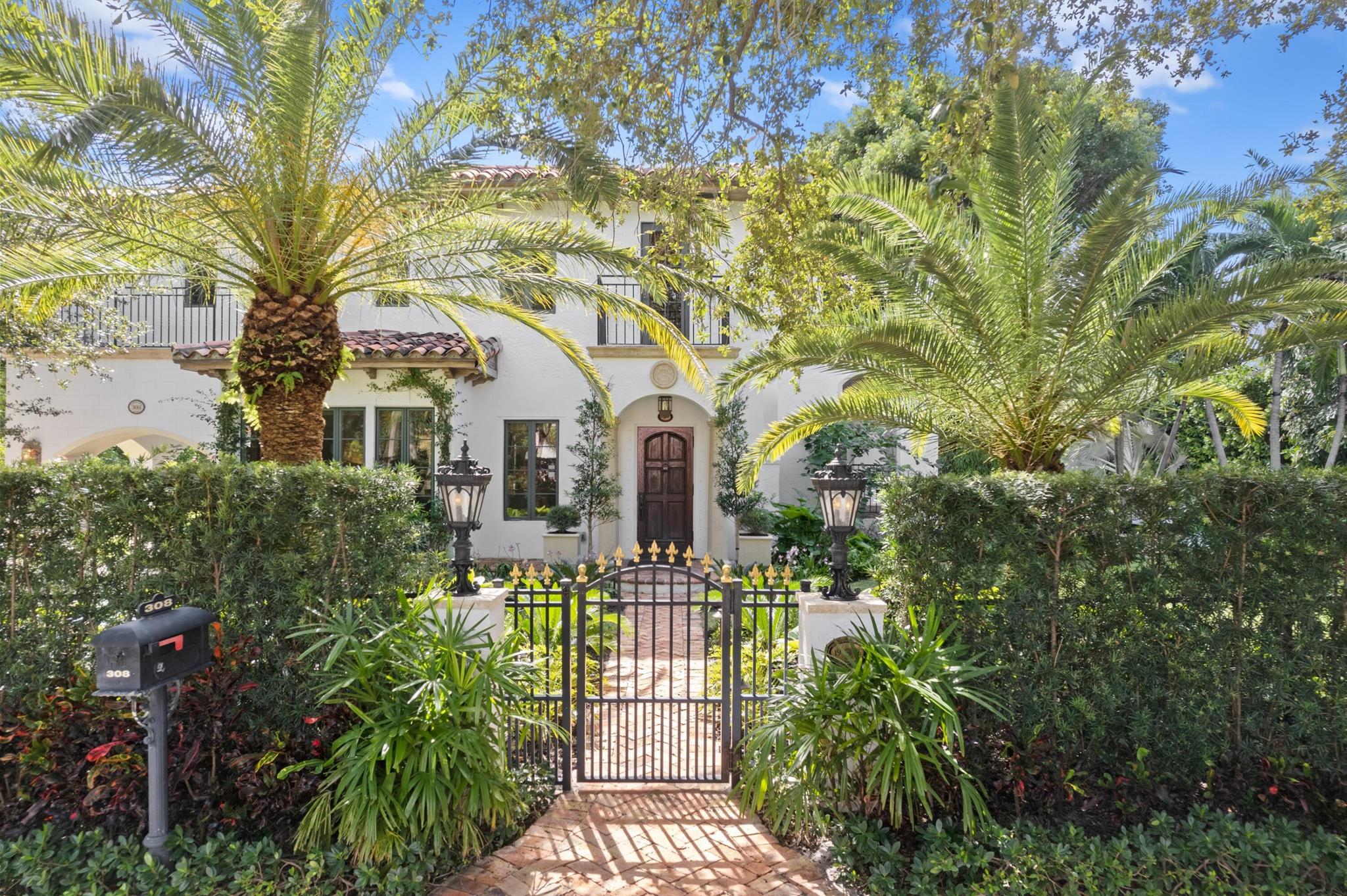 Welcome to this sophisticated Mediterranean oasis in the heart of West Palm Beach's historic El Cid district. This exquisitely updated and designer-furnished 3-bedroom, 3.5-bath main residence, complemented by a charming 1-bedroom, 1-bath guest cottage, sits on an oversized lot brimming with lush, manicured landscaping, enchanting brick terraces, and a stunning pool, creating a truly luxurious retreat. Inside, tall ceilings, graceful archways, and a gourmet kitchen with wine storage exemplify elegance and modern functionality. Each bedroom boasts an en-suite full bath and walk-in closet, providing comfort and privacy for all. Impact windows throughout offer peace of mind while allowing the serene, sunlit interiors to flow seamlessly with the verdant exterior spaces.