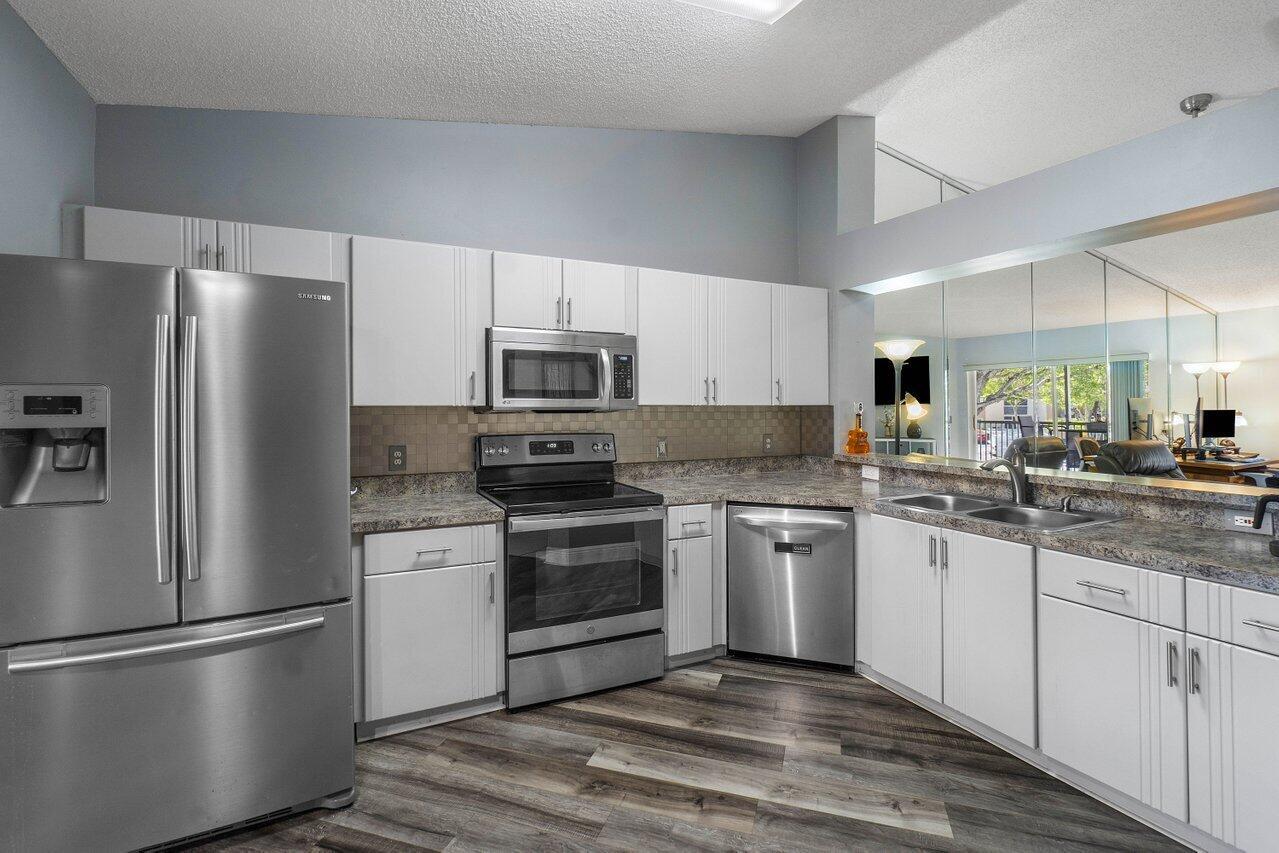 Don't miss this Updated Spacious & Bright 2-Bed 2 Full Bath Condo in Desirable 55 plus Community- Trent within Kings Point. Beautiful Courtyard Entrance. Tile and Laminate Flooring throughout (no carpet). High Vaulted Ceilings. Open Updated Kitchen W/Stainless Steel Appliances & lots of storage & extra built-in Cabinets. This condo has a front enclosed patio overlooking courtyard & screened in balcony in the back. Kings Point is an Active Adult Community that offers many Amenities: Clubhouse w/ indoor & outdoor pools, tennis courts, card rooms, fully equipped gym, State -of -the art Grand Ballroom. Courtesy Shuttle offered to the residents within community-- shopping malls, supermarkets and medical facilities. AC 2021, Water Heater 2023. Elevator Building