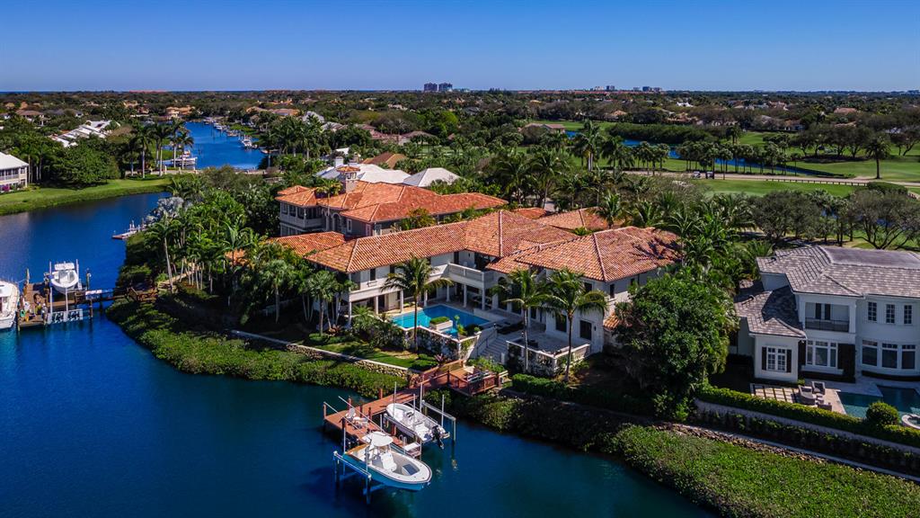An estate of incomparable elegance. This residence is situated on a half-acre-plus lot and overlooks the lush golf course and beautiful interior waterways of the much sought-after Admirals Cove. Magnificent in scale and lavish in luxury, this property is created for living and entertaining on a grand scale. Consisting of three wings with two elevators, this home features 7 bedrooms plus an office, 7 full and 2 half baths. An elegant entryway leads to a formal living room with 24-foot wood beam ceilings, a fireplace, and expansive water views. A formal dining room is adjacent to the massive gourmet chef's kitchen with dual 10-foot serving/seating islands, granite countertops, custom wood cabinetry, top-of-the-line appliances, commercial grade gas oven and cooktop, and so much more.