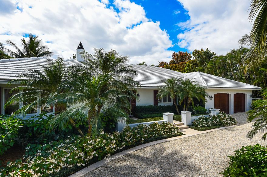 Stylish 3 BR/3 BA Bermuda situated on an exquisite 16,000 SF lot. Gardens designed by renowned landscape architect Morgan Wheelock surround the large pool with water feature. 2 car garage, newer A/C, generator.  The perfect getaway to enjoy the Palm Beach sunshine. Convenient beach access.