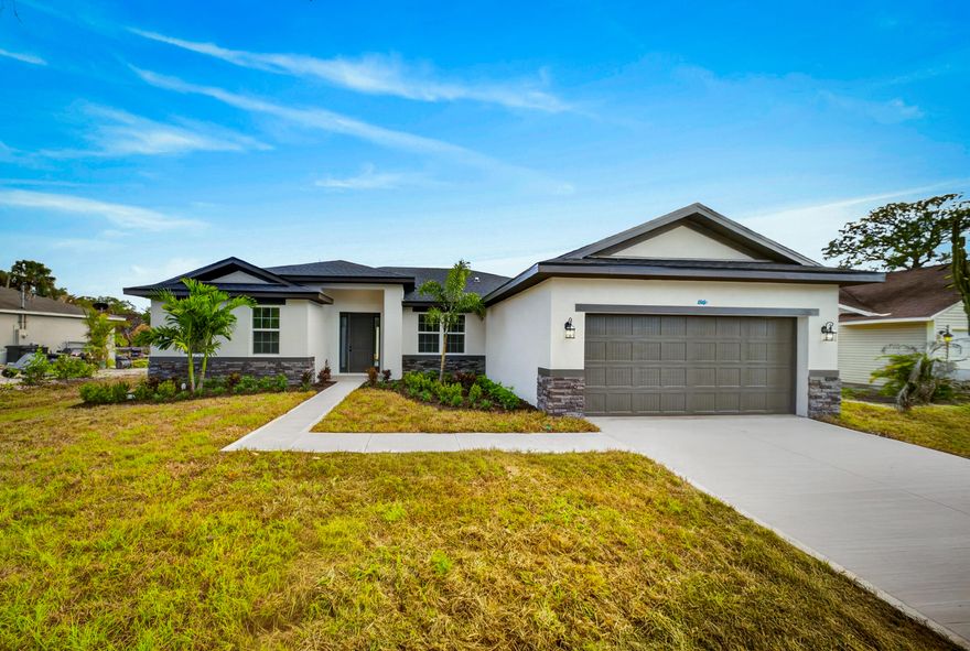 This 5 bedroom, 3 bath custom new construction home is our popular Shoreline model with some tweaks and loaded with upgrades.  This home features IMPACT windows and doors, 8 foot doors, huge kitchen with quartz countertops, waterfall edge island, custom tile backsplash, oversized plank tile throughout the home, custom shower tile to the ceilings with pebble tile on the shower floor and frameless glass shower enclosure in the master.  This home features 42 inch white shaker cabinets with soft close doors and drawers and also includes crown and light rail on the cabinets.  This is the only shoreline model currently available in Port St Lucie.  This home checks all the boxes and it is move in ready now and ready to close.  Ask about our builder incentives! Move in ready new construction home.  This home is ready to close.  Ask about our builder incentives for closing costs, etc.