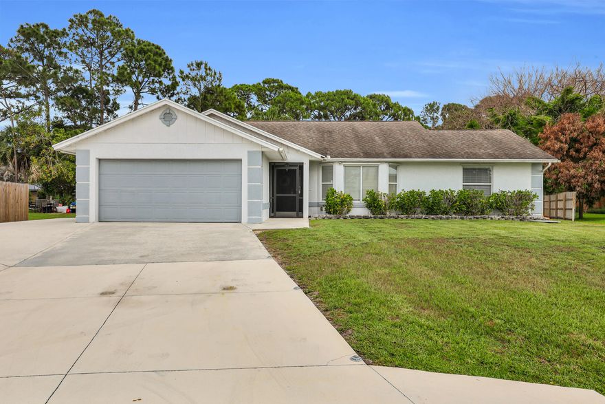 Paradise awaits! Welcome home to this beautifully remodeled 3-bedroom, 2-bathroom heated saltwater pool home situated on an oversized lot in one of the most desirable areas of Port St. Lucie,just minutes from shopping, restaurants, and I-95.  Step inside to a light and bright interior filled with natural sunlight, wood-look tile throughout, and a stunning remodeled kitchen featuring white shaker cabinets, quartz countertops, a center island, Samsung fingerprint-resistant appliances, and a large pass-through window with bar seating that opens to the spacious covered lanai, making indoor/outdoor entertaining effortless.  Both bathrooms have been tastefully updated with freshly retiled showers and new vanities, while the spacious backyard offers the perfect private retreat.   Enjoy your heated saltwater pool, resurfaced in 2022, along with a large, screened birdcage enclosure that was recently rescreened with updated hardware.  Additional features include hurricane protection for every window, a 2019 AC, an extended driveway with plenty of room for boats, trailers, or extra vehicles, and a private backyard ready for relaxing or entertaining. This move-in ready home is truly a must-see!"