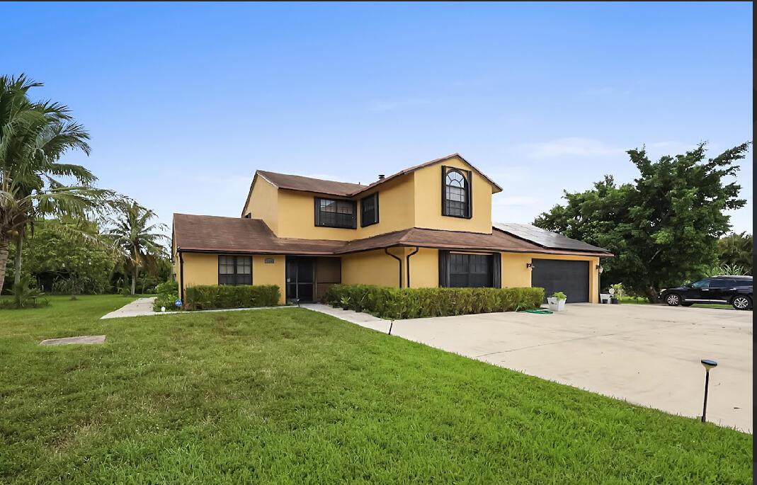 Large corner lot, 1.7 acres, 5 minutes to Northlake Blvd, 14 minutes to I-95, New Laminate floors, Fencing along Coconut and Orange Blvd. fruit trees, Mango, banana, coconut and sugar cane.Oversized cement driveway allows plenty of turnaround room, Sellers say's come with your offers.