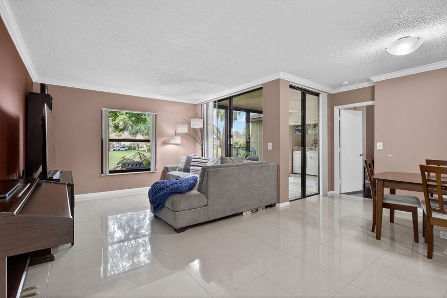 Enjoy effortless South Florida living in this beautifully updated Township residence. The interior features elegant porcelain tile floors throughout, a modern kitchen equipped with high ceiling cabinetry, granite countertops, and quality Stainless steel smart home appliances. The home is has full impact glass windows and sliding doors, a brand-new 2025 A/C system and a new in-unit washer and dryer. Relax in the screened-in patio, with a serene waterfront view of the canal. The building has a brand new roof, and all assessments have been paid by the seller. Parking is conveniently located right in front of your door and access to fantastic community amenities like the pool, tennis, and pickleball courts. This move in ready home is a perfect balance wit modern updates and everyday comfort. This home is occupied by the seller. Please contact the agent directly for showing dates and times available.