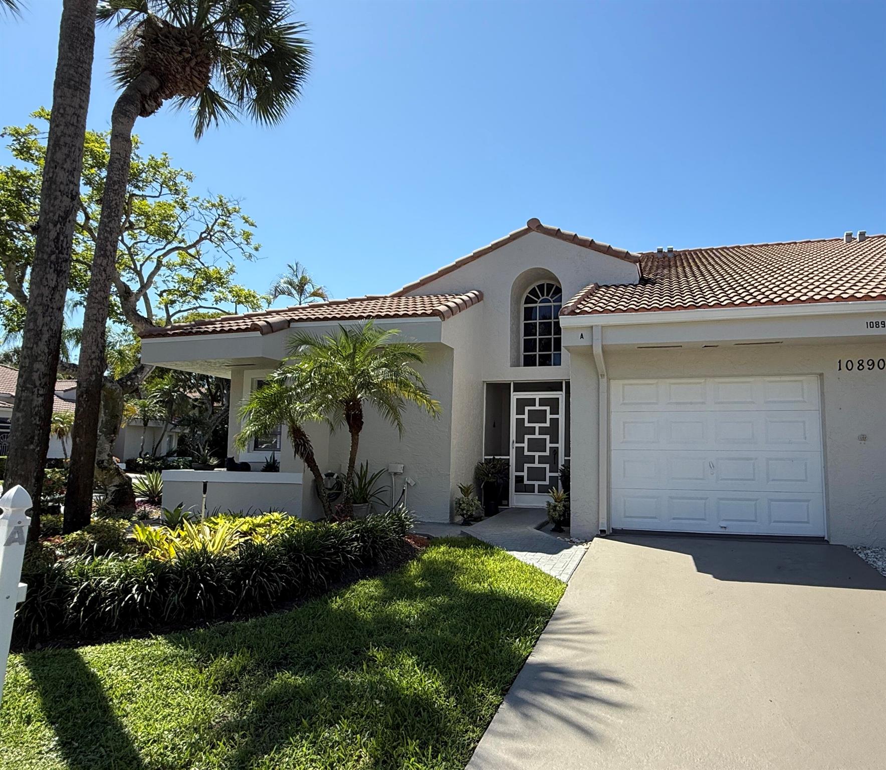 This spacious beautiful corner 2-bedroom, 2-bathroom villa is filled with natural light and a welcoming feel. Enjoy the serene lake view and beautiful landscaping from the glass-enclosed air-conditioned Florida room. The spacious layout offers comfortable living and dining areas, family room, large laundry room, one car garage, a clean and airy kitchen with newer cabinets, stainless steel appliances, quartz countertops, and two large split bedrooms. No carpet. HVAC was replaced 2020, roof 2016. The amenities in this 55+ community include Pool, tennis, clubhouse, and hot tub. Great West Boca location close to shopping, major roads, places of worship.