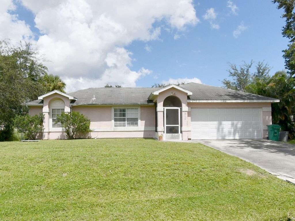 Photo of 317 SW Buxton Avenue, Port Saint Lucie, FL 34983 (MLS # R11064192)