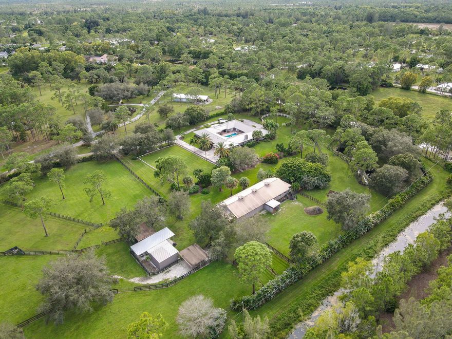Paradise in the Equestrian Community of Caloosa!  Privacy abounds on over 10 acres of finely landscaped and maintained grounds and arenas.  The property is a training facility suitable for any discipline.  This estate is move-in ready for the equestrian season, or your annual occupancy.  Every attention to detail is present in this property.  The elegant main house has generous sized entertainment areas, dining room seating for 12, chef's kitchen with bar and breakfast area, and 2 primary bedrooms with ensuite baths in addition to dens/offices.  All bathrooms have been renovated with quality grade finishes.