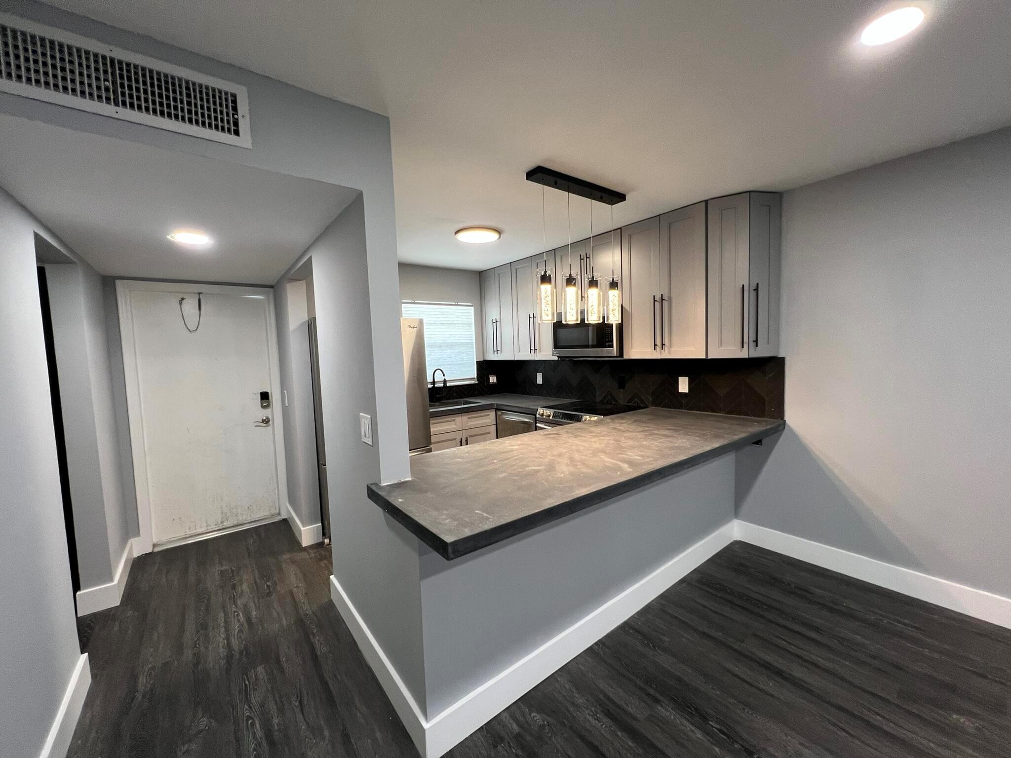 Fully Remodeled 1/1 near the heart of West Palm Beach, across from Palm Beach Outlets. With quick and easy access to I-95, over 20 restaurants, mainstream stores and shopping locations, this condo will no doubt meet all of your needs! Gorgeous and newly renovated unit equipped with a roomy glass shower, bright Carrara marble countertops, and new fixtures, you'll be sure to feel right at home. This condo has a large master bedroom with a walk-in closet, functional patio with top floor courtyard view, and stainless steel appliances all throughout! Beautiful Luxury Vinyl Plank floors and new 5'' baseboards gives a luxury feel.