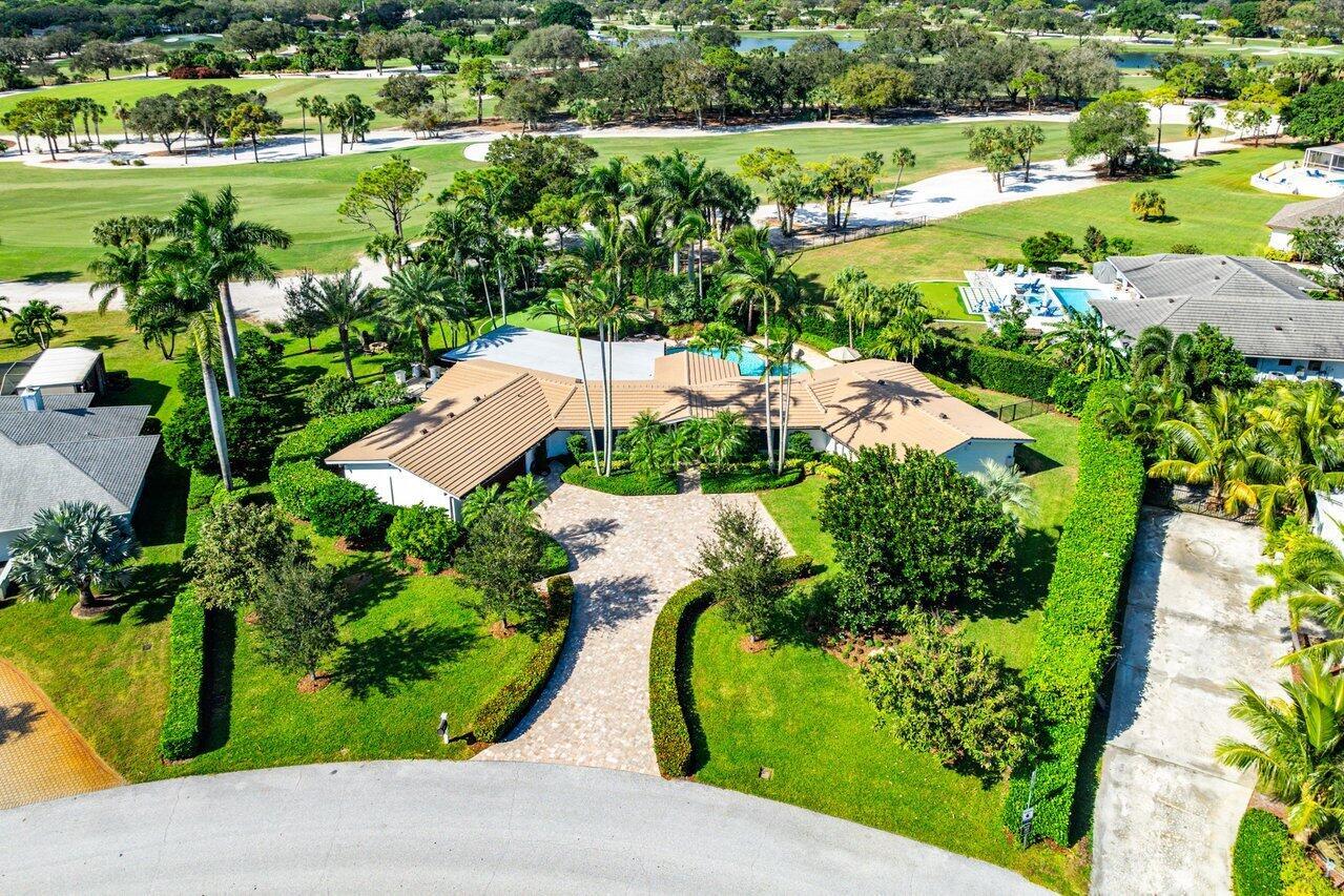 This exquisite mid-century ranch-style home, nestled on a serene half-acre lot, offers a perfect blend of modern updates and timeless elegance. With lush landscaping that provides exceptional privacy, you'll enjoy unparalleled sunset and golf course views from the comfort of your backyard, putting green and firepit. Boasting a thoughtfully designed modern kitchen with double islands and French doors that open to a private outdoor patio, the home is perfect for seamless indoor-outdoor living. All rooms that face the pool have access to the tropical oasis where the pool and pool deck were tiled and resurfaced last year. The home has been meticulously maintained with too many upgrades to list however the roof was new in 2019, new a/c's, backyard fences, painting inside and out in 2020.