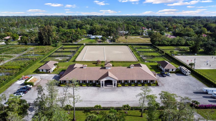 This beautifully maintained barn—constructed in 2017—offers a turnkey opportunity in a prime location. Positioned along a paved road, the property is thoughtfully laid out with 24 total stalls and 8 well-sized paddocks. The barn is divided into two distinct wings of 12 stalls each, designed for both functionality and comfort. Riders and staff will appreciate the well-appointed amenities, including two climate-controlled tack rooms, dedicated feed space, laundry area, half bath, and wash racks. There's plenty of room for parking, and the property includes shared access to a spacious arena complete with a mirrored wall and covered viewing area. In addition to the equestrian facilities, there is a 2-bedroom cottage as well as two 1/1 apartments that provide comfortable on-site living.