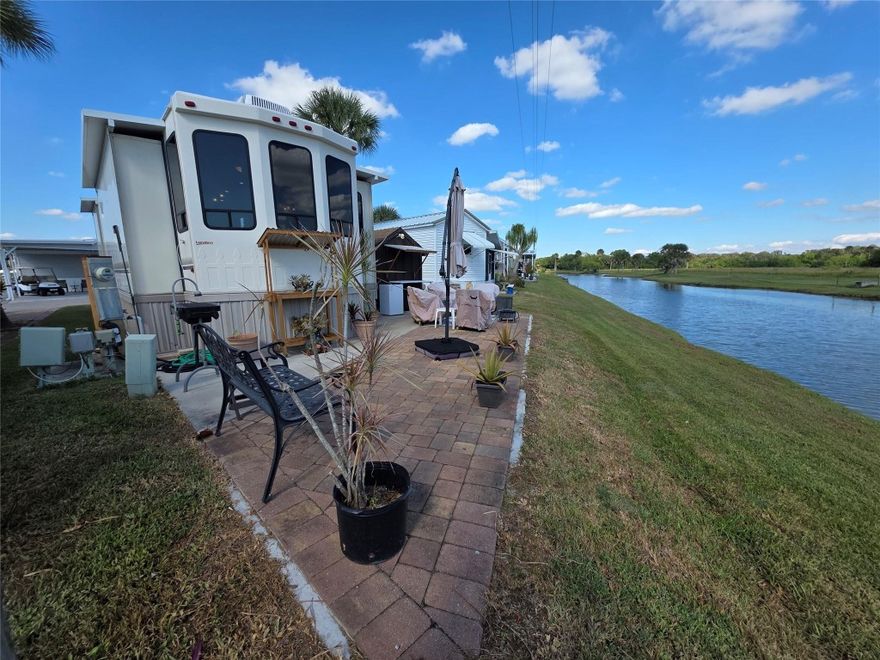 Waterfront home has the affordable ambiance you want in Waterfront Living !Enjoy Florida living in this premium 2014 Forest River Cedar Creek Cottage RV, perfectly positioned on a canal-front lot in a 55+ friendly gated community.Provides a comfortable full-time or seasonal living — a spacious king bedroom, stackable washer & dryer, a fully equipped kitchen with Island, dishwasher, central vacuum system-Media Center, Lots of Cabinets & Storage.Your paver brick patio overlooks the tranquil canal & landscape. The lot features an electrified shed, paver-trimmed concrete pad, and easy upkeep.Community Amenities Include:Heated saltwater pool-Clubhouse-Pickleball courts-shuffleboard-cornhole-pool hall-Dog Parks. Paved Streets, Marina, boat ramp & Docks with access to Lake 0 & Much more Buyers must apply & be approved by office prior to writing an offer. Application fee of  $75 for one & $100 for two. At least one person has to be 55 to apply .Mfgr Home specs are in the docs file on line. Roof has new dressing coat as of Nov.2025.All home contents remain. Patio furniture, outside refrigerator, planter stand & firepit are  not included with sale.