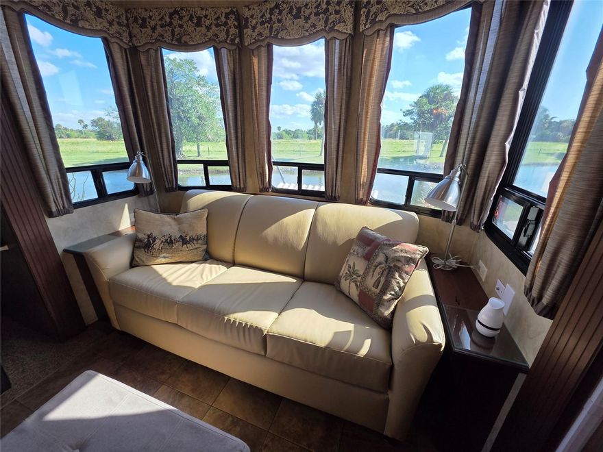 NEW PRICE !!! LUXURY Waterfront home! Deeded Lot! Premium OFFERING for a 2014 Forest River Cedar Creek Cottage RV, "all one level" perfectly positioned on a canal-front lot, with paver patio and scenic meadow views in a 55+ friendly gated community. Top notch amenities include: * spacious king bedroom, *stackable washer & dryer, *kitchen with Island, dishwasher, *central vacuum system, *Media Center, *Abundance of Cherry of Cabinets & Basement Storage. The lot features an electrified shed, paver-trimmed concrete pad, and easy upkeep.Community Amenities Include: Heated saltwater pool-Clubhouse-Pickleball courts-shuffleboard-cornhole-pool hall-Dog Parks. Paved Streets, Marina, boat ramp & Docks with access to Lake 0keechobee. HOA includes water, trash, lawncare & gated security! Buyers must apply & be approved by office prior to offer acceptance. Application fee of  $75 for one & $100 for two. At least one person has to be 55 to apply .Mfgr Home specs are in the docs file on line. Roof has new dressing coat as of Dec..2025.All home contents remain. Patio furniture, outside refrigerator, planter stand & firepit are negotiable in the sale.