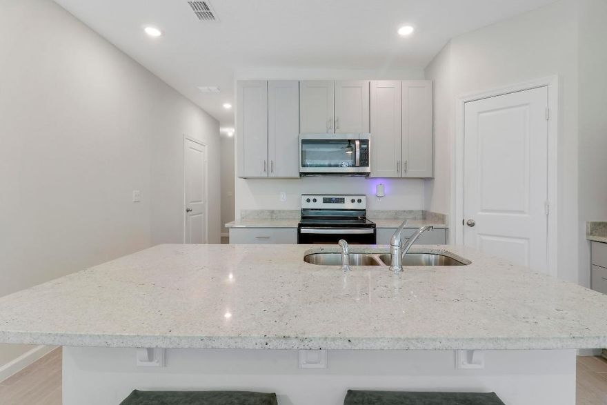 This immaculate, three-year-old townhome in Trillium is now available for SALE Offering 3 bedrooms and 2.5 baths, this home boasts an open floor plan on the main level. The modern kitchen features elegant gray shaker cabinets, sleek gray granite countertops, and stainless steel appliances. Guests will appreciate the conveniently located half bath on the ground floor. The spacious living and dining areas provide stunning views of a serene lake, with a beautiful preserve beyond. Upstairs, you'll find a versatile loft area, a well-appointed laundry room, a generous master suite, and two additional bedrooms. Prime location centrally located with easy access to shopping, dining, and schools. Built by Meritage, renowned for energy-efficient homes. Complete impact glass for low insurance costs This immaculate, three-year-old townhome in Trillium is now available for RENT Offering 3 bedrooms and 2.5 baths, this home boasts an open floor plan on the main level. The modern kitchen features elegant gray shaker cabinets, sleek gray granite countertops, and stainless steel appliances. Guests will appreciate the conveniently located half bath on the ground floor. The spacious living and dining areas provide stunning views of a serene lake, with a beautiful preserve beyond. Upstairs, you'll find a versatile loft area, a well-appointed laundry room, a generous master suite, and two additional bedrooms. Prime location centrally located with easy access to shopping, dining, and schools. Built by Meritage, renowned for energy-efficient homes. Complete impact glass for low insurance costs

and stress-free hurricane seasons.
Garage for 1 car and 2 car driveway spaces.
Can be rented immediately, offering excellent investment potential.
Don't miss this opportunity to own a practically new, move-in-ready home in a prime location. For more information or to schedule a viewing. Must see.