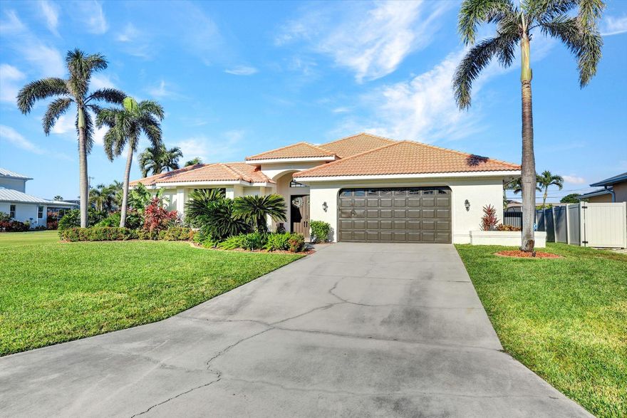 TURNKEY COURTYARD POOL HOME W/ IN-LAW SUITE BY AUBUCHON! Located in the Rose Garden area, just a 2-min walk to Tarpon Point Marina, this 3BR, 3BA home boasts over 2200 sq ft under air and an oversized garage. Enjoy a heated pool w/ waterfall in a lush private courtyard, complete with built-in grill, outdoor shower & 1BR/1BA guest suite. The main home features high ceilings, crown molding, navy & white shaker cabinets, quartz counters, wine fridge, and updated kitchen with SS appliances. The primary suite offers tray ceilings, dual walk-ins, and pool access. Tile roof, new plumbing system, WiFi thermostat, landscape irrigation controller, and epoxy garage floors add peace of mind. Walk to Rotary Park, shops & dining. Furnishings included!
