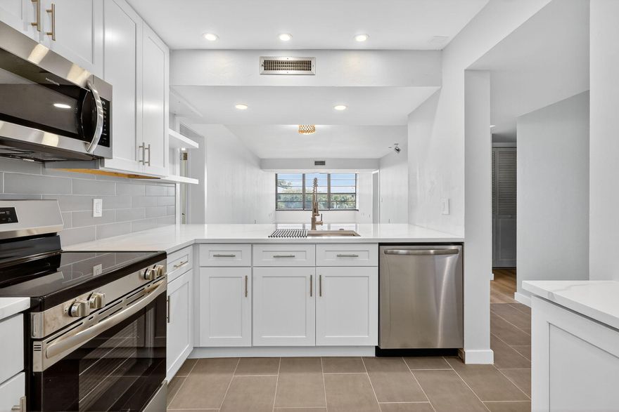 Newly remodeled condo MINUTES from Downtown West Palm Beach and PBI Airport! Spacious modern style 2/2 with a large storage/laundry room that could be made into a den, gym, etc. Entrance through private gate at Land of the Presidents. Quartz countertops and ceramic tile. Custom closets offered by seller in master bedroom and storage. New 2026 Roof being installed this year that the SELLER IS PAYING FOR IN ADVANCE!!