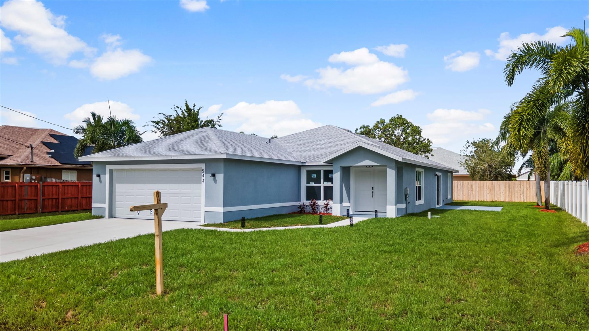 NEWLY BUILT HOME NEAR TREASURE COAST HIGH SCHOOL, EASY ACCESS TO I-95 AND THE TURNPIKE FOR THE COMMUTERS. GREAT WALKING NEIGHBORHOOD SURROUNDED BY NEWER HOMES. CITY WATER AND SEWER, THE PROPERTY IS ALL TILED WITH IMPACT GLASS WINDOWS, MODERN SHOWERS, STAINLESS STEEL APPLIANCES, FARM - HOUSE SINK, WINE COOLER INTEGRATED, QUARTZ COUNTER TOPS, A VERY PRACTICAL POT FILLER OVER THE STOVE FOR YOUR GOURMET STYLE NEEDS, MATURE FOX TAIL PLAMS AROUND THE HOME, THREE SIDES OF THE PROPERTY ARE FENCED, THE LOT CAN FIT A BOAT OR AN RV. EFFICIENT LIGHTING. HIGH VAULTED CEILINGS, GLASS SHOWER DOOR IN MAIN BATHROOM, A BEAUTIFUL HOME THAT HAS NEVER BEEN LIVED IN. SEE THIS GEM BEFORE IT IS GONE!