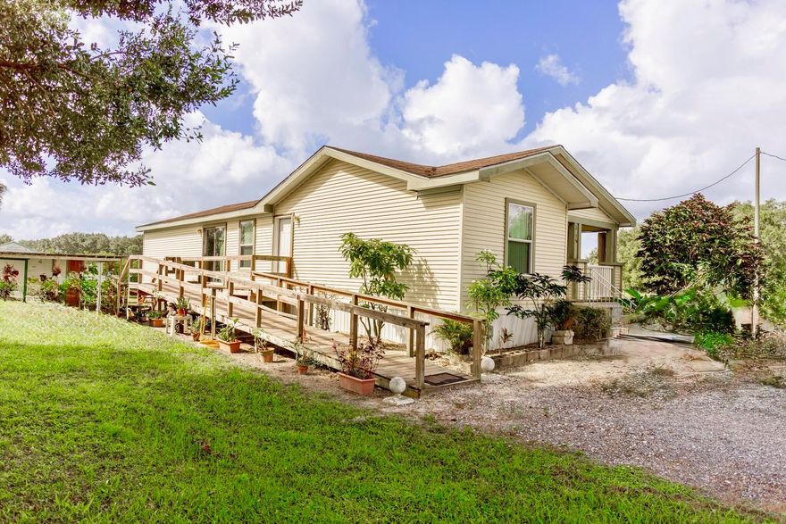 Viking - 2006 3 Bedroom, 2 Bath Palm Harbor  manufactured home on 3.75 acres. This spacious property features updated laminate flooring throughout, a split floor plan, and an open-concept layout perfect for comfortable living. Dining room and inside Laundry room Enjoy the charm of mature trees, garden areas, a wood ramp, and two storage sheds for all your outdoor needs.If you've been dreaming of peaceful country life this is it! measurements are approximate.