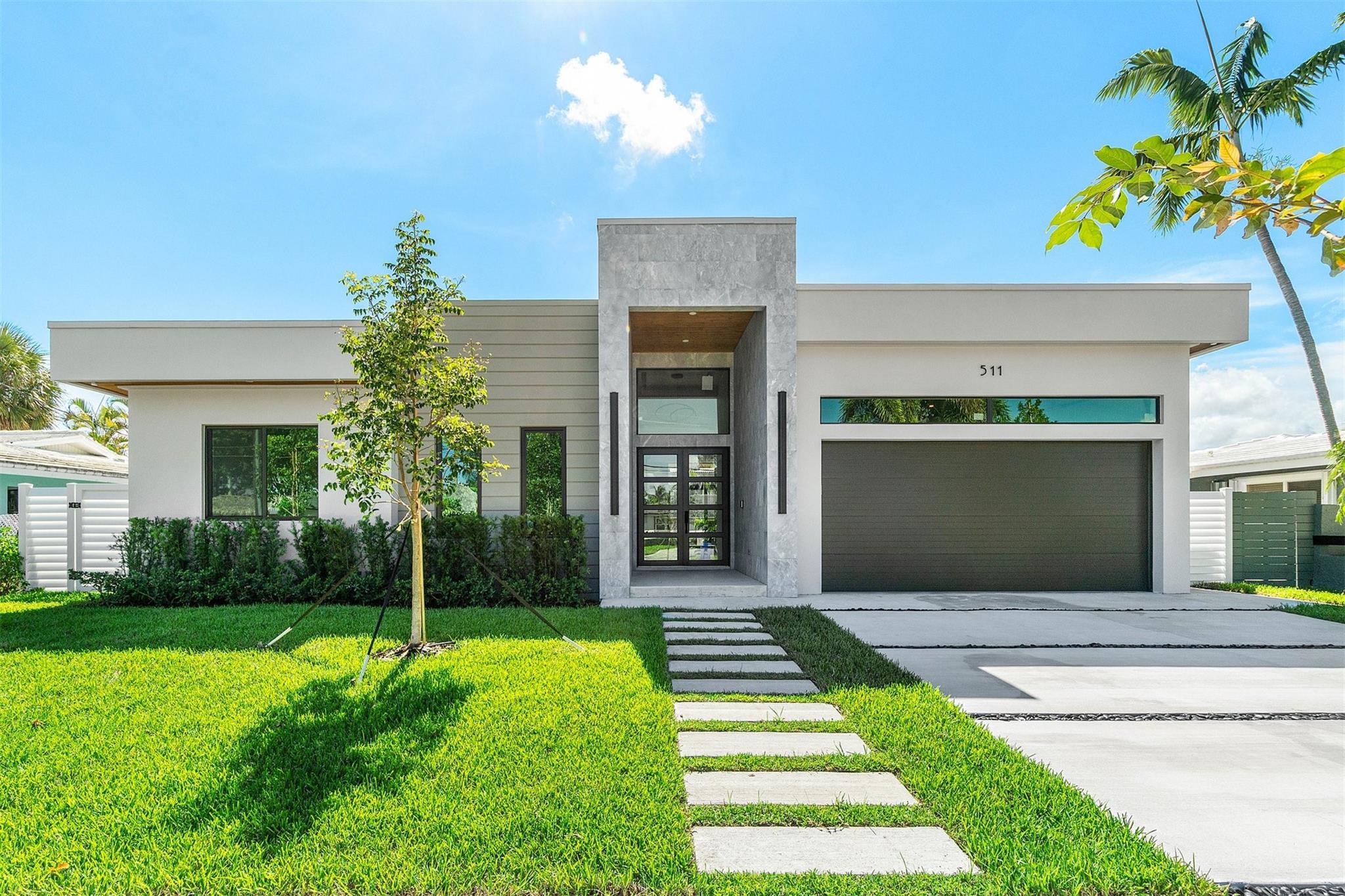 Modern waterfront home built for peace of mind and designed for the ultimate Florida lifestyle. New construction with ocean access, featuring a new concrete dock, saltwater pool, spa, large covered patio, cabana bath, and full outdoor kitchen. Step inside to one-level living with high ceilings, porcelain floors, marble baths, custom built-in cabinetry, designer lighting, and luxury finishes throughout. The gourmet kitchen includes premium appliances and a modern design. Enjoy seamless indoor-outdoor living, perfect for entertaining or quiet waterfront relaxation. Minutes to the beach, waterfront dining, and airports.