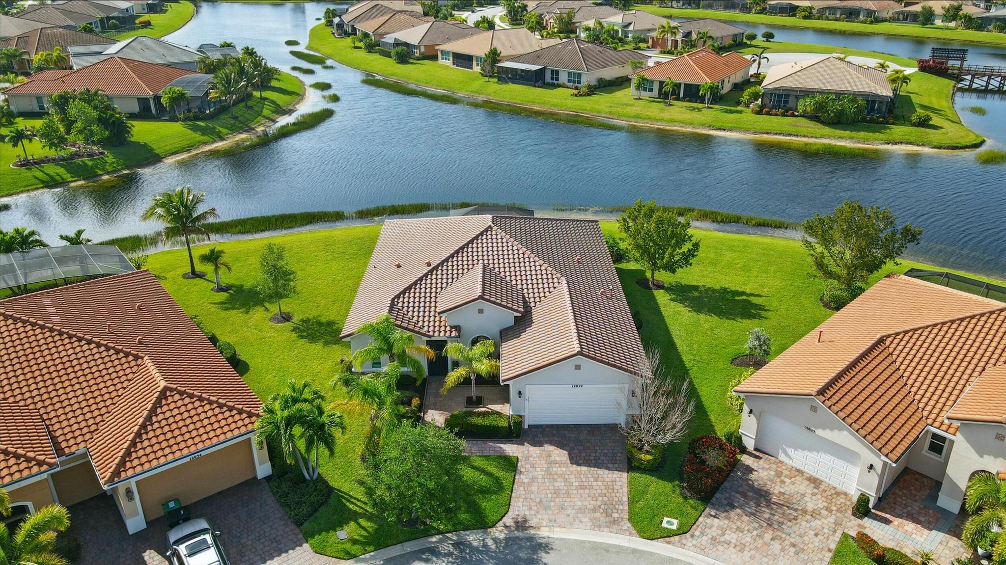 Lakefront luxury meets modern comfort in this 3BR + Den, 3BA gem nestled in a cul-de-sac! Enjoy Stunning sunset views from your screened patio. Features impact windows, Dual Master Suites, barrel tile roof, new tankless water heater, whole house water filtration/softening system, crown molding/plantation shutters, wainscoting and freshly painted interior, Tile in living areas, luxury vinyl in bedrooms, TV mounts, dimmer switches, bidets on all bathrooms, energy efficient LG washer and dryer, new fans/lights in every room.The Kitchen boasts granite island, soft touch faucet, backsplash, recessed/under-cabinet lighting, pull out trash bins and stainless steel appliances.Master suites equipped with towel warmers, pebble stone shower floors and a dual dock retrofit shower system.A rare gem!