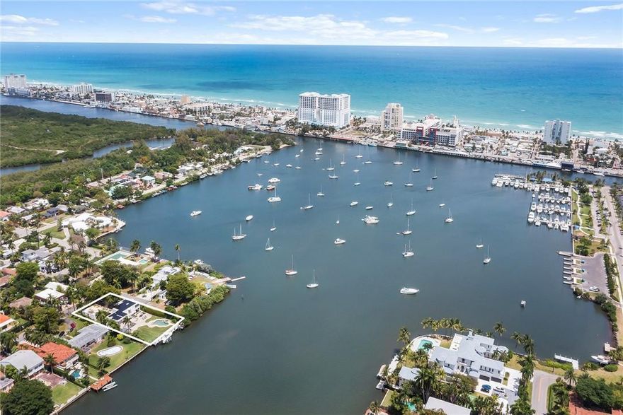 Overlooking Hollywood’s prized North Lake, this 5,000+ sq ft estate w/ unparalleled vistas has starred in movies, telenovelas + more. Are you its next star? Backyard paradise w/ 80-foot dock, boat/jet-ski lifts + no fixed bridges to ocean. Newly reinforced seawall, pool, jacuzzi, tile + pops of towering palms throughout. Only the finest materials – reinforced concrete, 108 solar panels, Sonos audio + new water, sewage, natural gas lines. Residence gleams w/ marble, natural light + one-of-a-kind semi-spiral staircase w/ Mondrian steel railing. Kitchen w/ granite counters + stainless steel appliances (commercial Thermador oven). Massive primary suite w/ water views, marble-clad ensuite + huge walk-in w/safe. Main level in-law suite + guest room in separate building. A dream location + home!