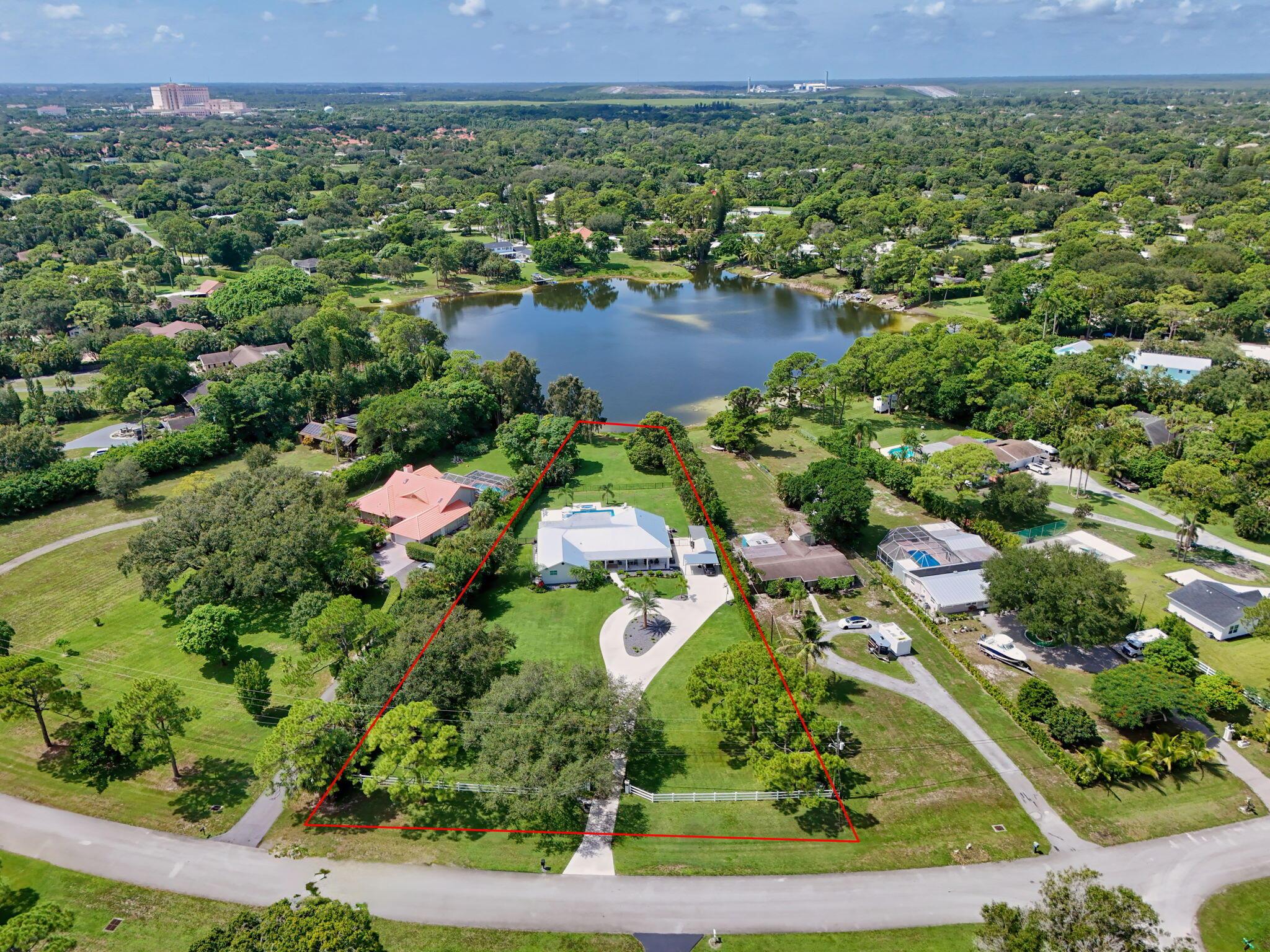 Rare Lakefront Estate on 1.3+ Acres - Fully Remodeled, No HOA!Seize this extraordinary opportunity to own a stunning 5-bedroom + office, lakefront home on a sprawling 1.3+ acre lot, free from HOA restrictions. This meticulously remodeled CBS-constructed residence blends luxury and functionality with top-of-the-line features. Enjoy peace of mind with impact glass windows, a new metal roof, and a secure front entry gate. The gourmet kitchen is a culinary masterpiece, boasting high-end appliances, custom cabinetry and oversized Island.The home's open-concept design showcases vaulted ceilings, creating an airy and grand atmosphere. Relax in the state-of-the-art movie theater w/ full Sports Bar or unwind by the brand-new 17x34 pool and Hot tub, complete with a fully equipped summer kitchen