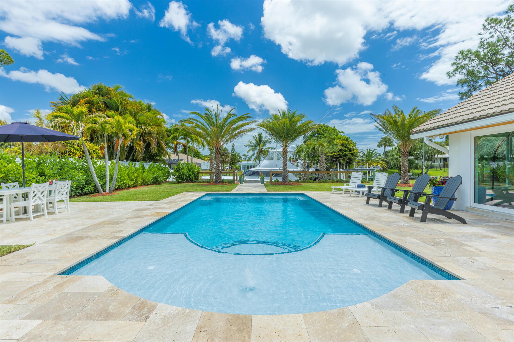 WATERFRONT OCEAN ACCESS & SALTWATER POOL W/ PRIVATE DOCK AND TIKI HUT. Positioned at the St. Lucie River, this beautifully remodeled home is complemented with a modern coastal decor and is fully equipped and furnished for your stay. Whether you're an avid boater or just looking for a gorgeous spot to relax, you're sure to find yourself sunbathing by the crystal clear pool that overlooks a private dock where you can tie up or fish for a variety of species. The dock is equipped with a cleaning station, electric, & water for your watercraft. Relax & swing under the large private Tiki Hut while watching your favorite show & eating your favorite meal fresh off the grill. Currently accepting next season offers Monthly Rates: Off-Season: $8500; Mid-Season:$12K; Season: $16K.(taxes&fees apply)