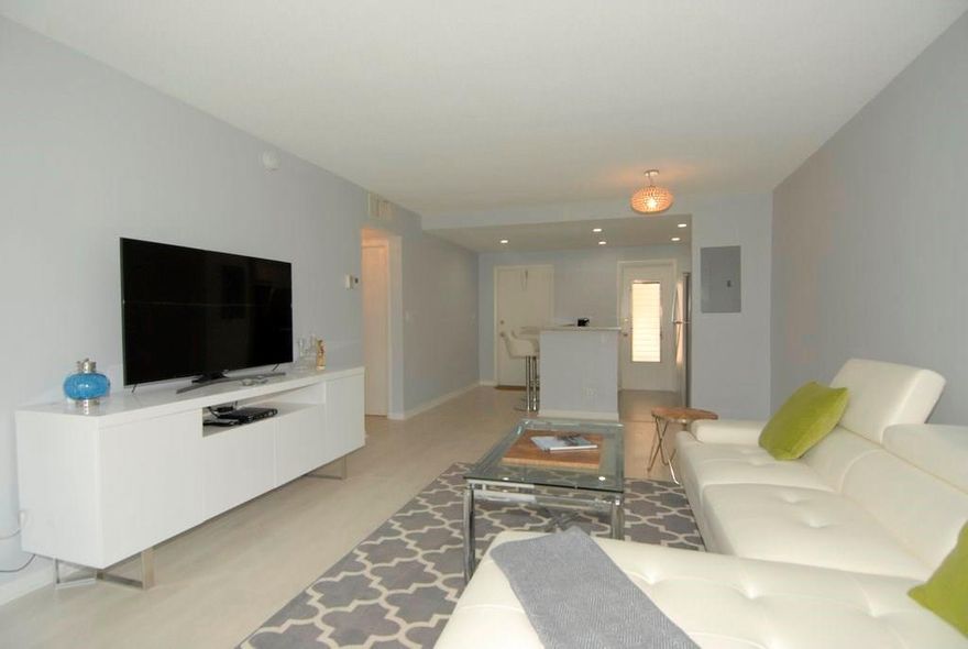 Gorgeous two bedroom/two bath Condo Best Building in Leisureville! NEW Roof 2017 Free golf for owners All NEWLY renovated with wall removed for Open Concept NEW Granite counters and Bar NEW Kitchen Cabinetry Designer pergo flooring throughout NEW Renovated Bathrooms Frameless Glass doors Rain Showerhead Recessed lighting NEW Tile in Bathroom and Porch  NEW Hunter ceiling fans NEW light fixtures in LR and Bathrooms Pets ok NEW Upgraded Electrical Panel Freshly painted NEW wooden window treatments