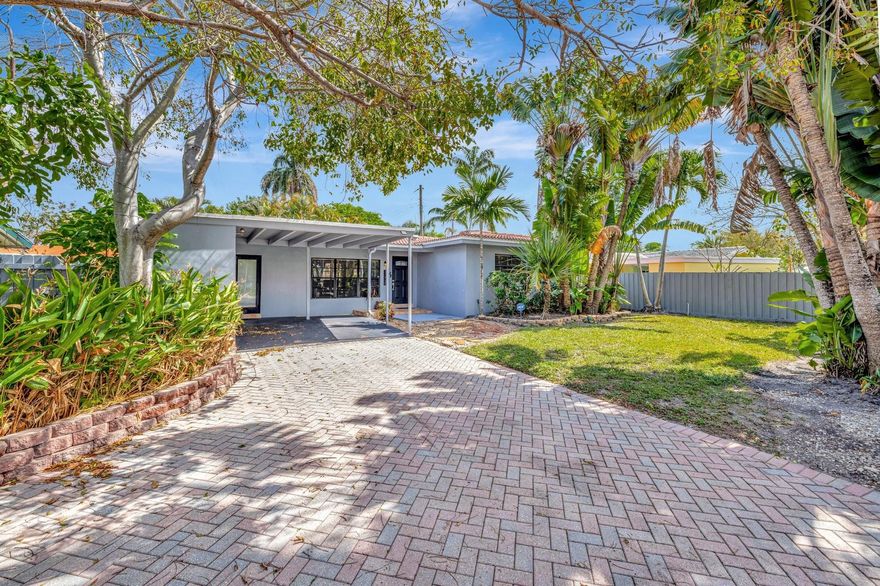 Ideally located between Fort Lauderdale's desirable Tarpon River & Croissant Park neighborhoods, this home offers quick access to Downtown, Las Olas, beaches, & airport makes an unbeatable combination of convenience & lifestyle. Step inside to a bright open-concept layout filled with natural light from the expansive windows overlooking the screened porch & spacious backyard. Recent updates include luxury vinyl flooring throughout, the kitchen stands out with sleek black cabinetry & stainless steel appliances, &  new washer/dryer. Both bedrooms are generously sized, with the primary featuring a walk-in closet and en-suite bath. Additional features to home: a dedicated laundry room, carport with exterior storage, and a large paver driveway providing ample parking.