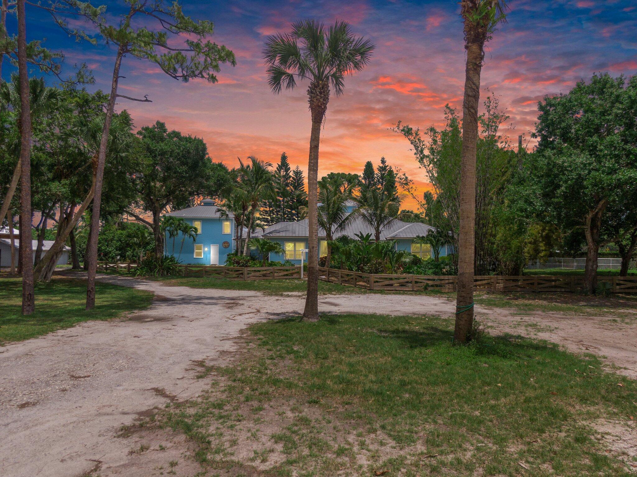Live where you can ride, relax, and entertain on this rare 3-acre equestrian estate in Stuart. Gated and fully fenced, this private compound includes a 3BR/2BA main home with screened pool patio, a detached 1BR/1BA guest house, 3-stall barn with tack/feed room, large workshop, and two storage buildings. Zoned for residential/agricultural use, with direct golf course access. Perfect for equestrian enthusiasts, contractors, or those seeking space, privacy, and flexibility. Pet-friendly, with a 7-ft concrete privacy wall and special drainage system. Long-term lease preferred.