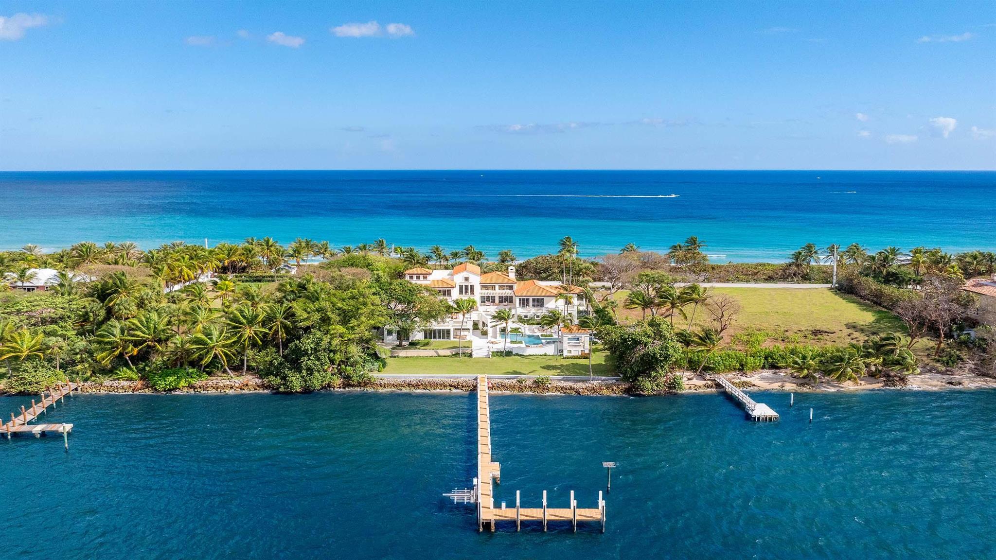 Recently updated, this stunning Ocean-to-Intracoastal Manalapan compound with beach house is situated on almost two acres with 150 feet of direct ocean and Intracoastal Waterway frontage. Boasting over 19,600 total square feet, the residence offers scenic ocean and Intracoastal views throughout and eight total bedrooms including a luxurious primary wing. Many upgrades include new flooring; all new bathrooms; new impact sliders; and new cooler unit in wine room. Multi-level terraces and balconies provide ample room for outdoor living and dining. The manicured grounds include resort-style pool with spa; new landscape; and sprawling lawn that overlooks 150 feet of Intracoastal waterfrontage. Boaters will appreciate the large dock and new seawall plus easy ocean access via nearby inlets.