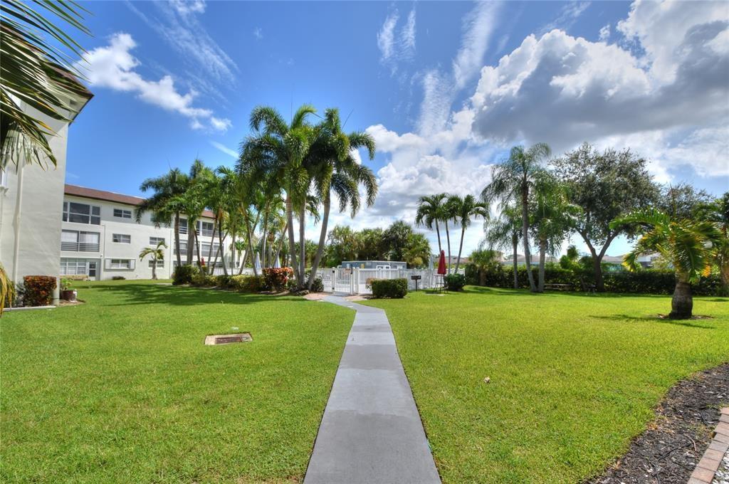 Large 2nd floor one bedroom (large walk-in closet), one & a half bath condo located in Deerfield Beach. Features laminate (bedroom) and tile (all other areas) flooring, Kitchen has been opened up and includes dishwasher, built in microwave, open island to hold barstools and lots of cabinets. Patio overlooks the pool. Onsite laundry facilities. 1 assigned parking spot. Minutes from beach,  turnpike and 95. Rapid Move in. Pets okay with additional deposit and small monthly fee.
