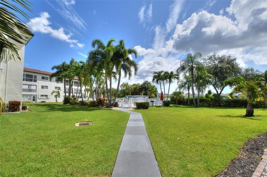 Large 2nd floor one bedroom (large walk-in closet), one & a half bath condo located in Deerfield Beach. Features laminate (bedroom) and tile (all other areas) flooring, Kitchen has been opened up and includes dishwasher, built in microwave, open island to hold barstools and lots of cabinets. Patio overlooks the pool. Onsite laundry facilities. 1 assigned parking spot. Minutes from beach,  turnpike and 95. Rapid Move in. Pets okay with additional deposit and small monthly fee.