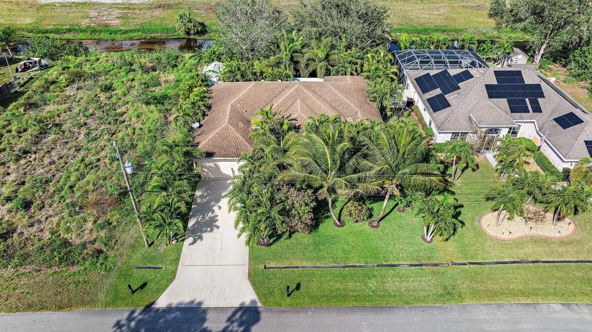 What a great home in a beautiful community in the west Port Saint Lucie area! This spacious home with a well attended garden is ready for you to make your own. 4 bedrooms, 2 baths on a large lot. As you enter you will immediately notice the spacious interior flooded with natural light. Wide open living, dining, family room leads easily to a chef's kitchen with quartz countertops and stainless steel appliances. The primary bedroom is oversized with a wonderfully laid out bathroom with 2 sinks, soaking tub and shower. The remaining bedrooms are well laid out and very nice sized rooms.