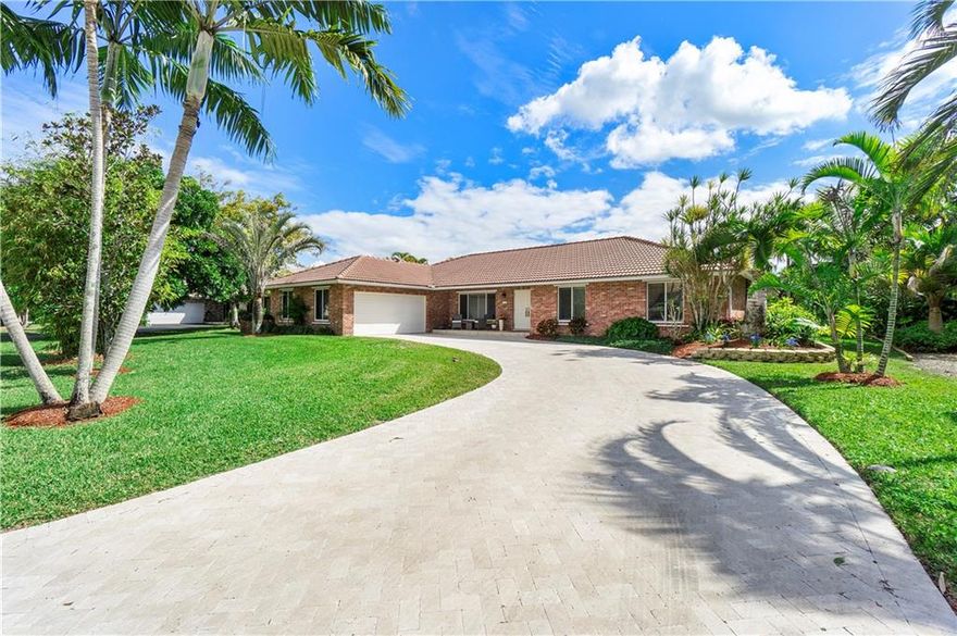 *Public Tours 12-3pm Feb. 12 & 13th*  Wow what a view! You MUST see this Stunning waterfront 4 Bedroom 2.5 Bath pool home in sought after Cypress Isle! Custom-built & completely updated ~ this HOME has it all! Spacious 3460 sq ft design & Saturnia marble floors throughout living areas. Sexy eat-in kitchen remodeled in 2021. Great use of mixed metals, large accent island w/Calcutta quartz, Bosch appliances, custom solid wood soft close cabinets w/one-of-a- kind inserts & roll out coffee bar & large pantry. Large bedrooms w/Multiple walk-in closets. Wait until you see this remodeled master bath ~ his & hers vanities & walk-in closets, freestanding bathtub & large seamless glass shower. Plantation shutters accent all windows. Tropical pool w/heated spa, waterfall & lanai. No HOA.