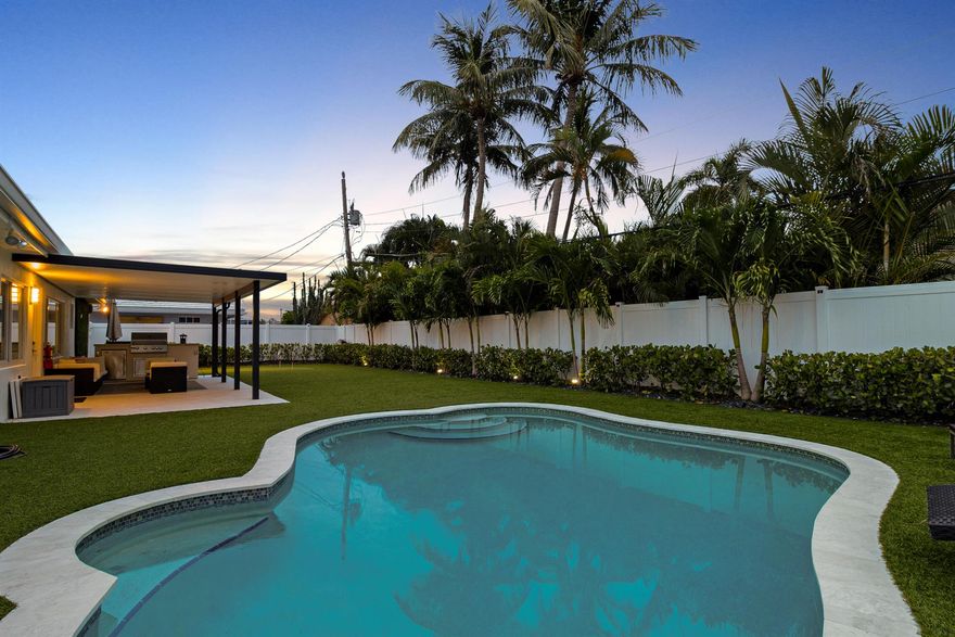 Live the Lighthouse Point lifestyle just steps from Cap's Place and Frank McDonough Park! This fully SOLAR-powered (owned solar) 4 bed, 4 FULL bath home blends cutting-edge technology with elevated coastal comfort, boasting over 2,600 sqft of living space, ideal for entertaining. The chef's kitchen stuns with a leathered honed quartz island, 8-burner GAS RANGE (120-gallon tank), oversized 66'' built-in refrigerator and freezer, MIELE BUILT-in COFFEE system, and wine fridge. Bright, open-concept living areas feature white oak engineered hardwood flooring and a sleek ventless bioethanol fireplace. Dual A/Cs (2024 & 2011), two tankless water heaters (2021), IMPACT WINDOWS, updated electrical panels and PVC PLUMBING to ensure peace of mind. Love the furniture too? Furniture can be