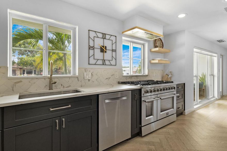 SELLER WILLING TO OFFER A $10,000 CREDIT AT CLOSING! Live the Lighthouse Point lifestyle just steps from Cap's Place and Frank McDonough Park! This fully SOLAR-powered (owned solar) 4 bed, 4 FULL bath home blends cutting-edge technology with elevated coastal comfort, boasting over 2,600 sqft of living space, ideal for entertaining. The chef's kitchen stuns with a leathered honed quartz island, 8-burner GAS RANGE (120-gallon tank), oversized 66'' built-in refrigerator and freezer, MIELE BUILT-in COFFEE system, and wine fridge. Bright, open-concept living areas feature white oak engineered hardwood flooring and a sleek ventless bioethanol fireplace. Dual A/Cs (2024 & 2011), two tankless water heaters (2021), IMPACT WINDOWS, updated electrical panels and PVC PLUMBING to ensure peace of mind. Love the furniture too? Furniture can be included in the sale for a turnkey experience, if desired. Outside, enjoy a resort-style SOUTH FACING EXPOSURE backyard with premium synthetic turf, a 3-hole putting green, HEATED saltwater pool, newly insulated pergola, and full outdoor kitchen. Home includes 3 high-capacity backup batteries (up to 4 days of off-grid power), and EV charging station (220V). Double primary shower, beautifully updated baths throughout, and an expansive layout complete this exceptional offering in one of Lighthouse Point's most desirable walkable pockets.  

The home has been a successful vacation rental and can easily continue generating income if you're looking for an investment or part-time use.