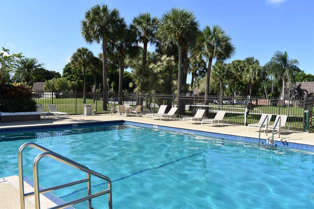 Beautiful Heritage Village Townhouse in West Palm Beach. Two assigned parking stalls right outside the unit. Just steps from the neighborhood pool. Private outdoor patio with new PVC fence. Large grassy backyard area along the waterway. Washer & Dryer in unit. 2 cars max per unit and No Motorcycles per HOA.